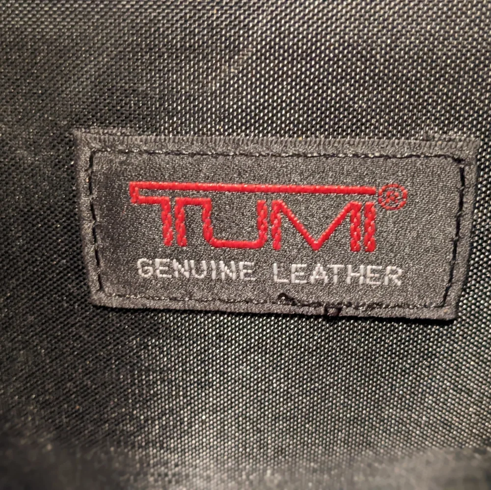 Black Tumi expandable briefcase. Fits 15